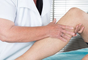 Therapist working with patient's knee
